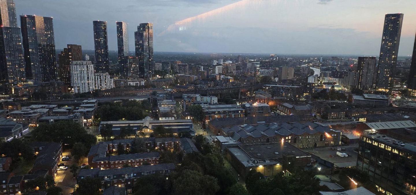 Manchester city centre at dusk, towers on the skyline